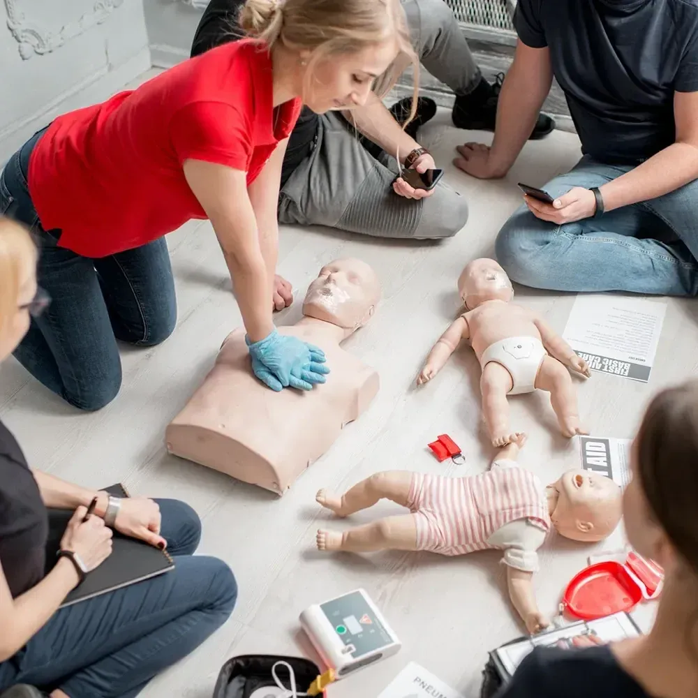 Students practicing adult and infant CPR in a class run by Pulse Savers, a first aid training company in Toronto