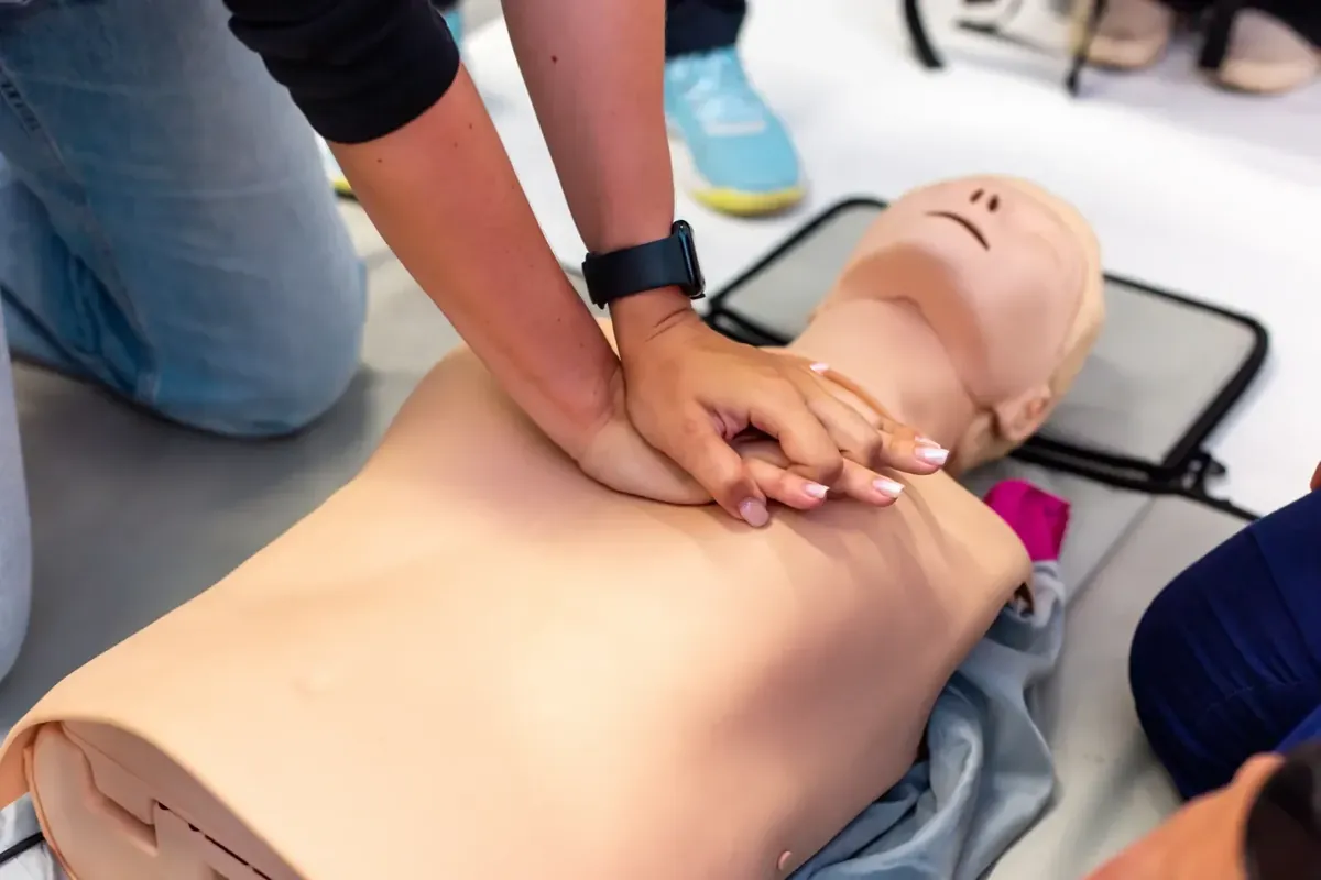 Hands performing chest compressions: contact Pulse Savers about CPR training